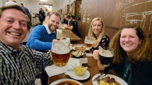 scott-laurie-prague-beerhall Scott and Laurie, enjoying dinner and a beer with two locals, at a beer hall in Prague, Czech Republic