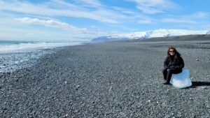 Laurie sitting on the remnant of an iceburg, on Diamond Beach in SE Iceland.