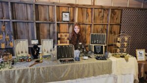 Macy selling her jewelry at a local craft fair